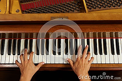 Woman's hands on the keyboard of the piano closeup Stock Photo