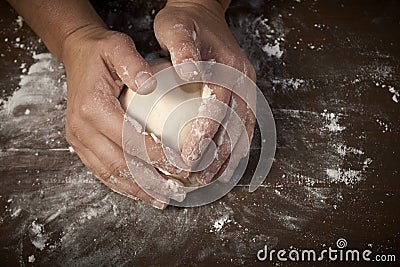 Woman's hands kneading dough Stock Photo