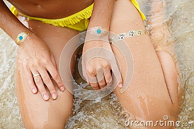 Woman's hands legs with sticker tatoo in the sea Stock Photo