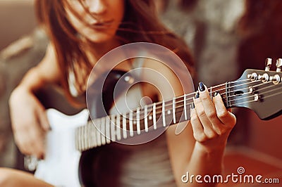 Woman's hands playing acoustic guitar, close up Stock Photo