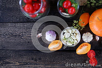 Woman`s hands rolls glass preserves with jars sealer. Making homemade vegetables for coronavirus crisis. Tomatoes, pumpkins, Stock Photo