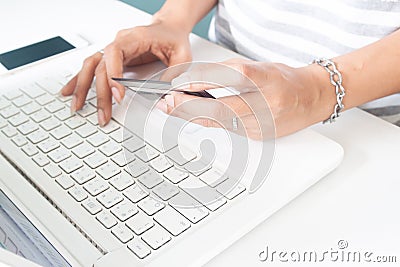 Woman`s hands using laptop and credit card. Online payment, internet banking. Stock Photo