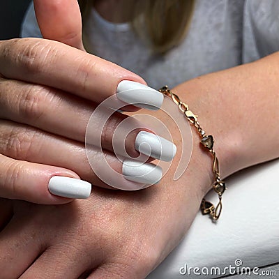 Woman`s hands with white nails Stock Photo