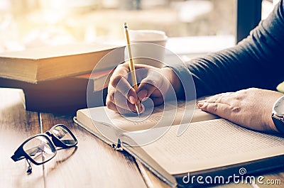 The woman`s hands are writing notes in a notebook. Stock Photo