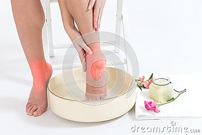 Woman's legs ankle pain in high heels relaxing with bathfoot Stock Photo