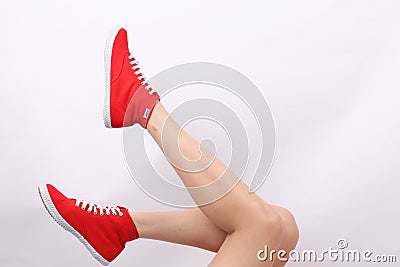 Woman`s legs with Red Tomy Takkie Trainers Editorial Stock Photo