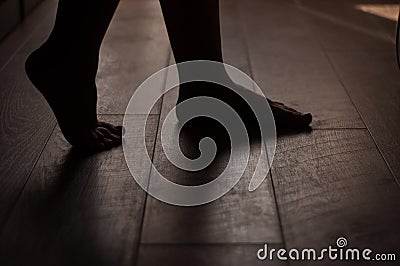 Legs on a warm wooden floor Stock Photo