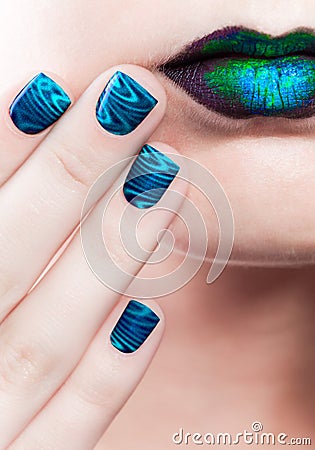 Woman's lips with beautiful multicolor Minx nails and make-up Stock Photo