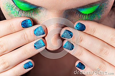 Woman's lips with beautiful multicolor Minx nails and make-up Stock Photo