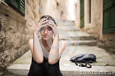 Woman with sad face crying.Sad expression,sad emotion,despair,sadness.Woman in emotional stress and pain.Woman sitting alone on th Stock Photo