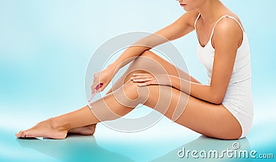 Woman with safety razor shaving legs Stock Photo