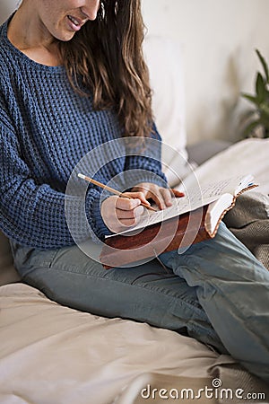 Woman sat writing in her journal Stock Photo
