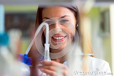 Woman scientist carrying out experiment in research laboratory Stock Photo