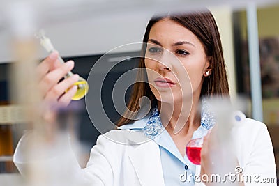 Woman scientist carrying out experiment in research laboratory Stock Photo