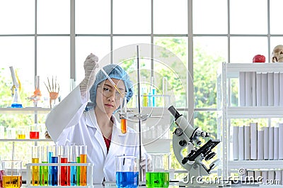 The woman scientist doing experiment. Stock Photo
