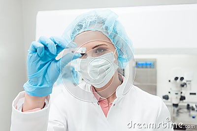 Woman scientist showing her newest biotech experiment in lab Stock Photo