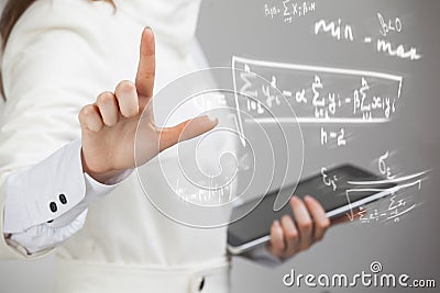 Woman scientist or student working with various high school maths and science formula. Stock Photo