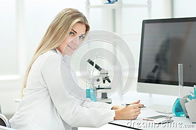 Woman scientist in the workplace in the laboratory . Stock Photo
