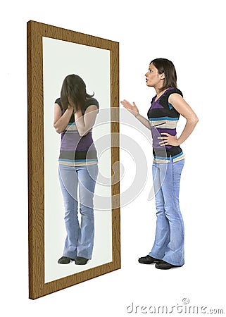 Woman scolding herself in a mirror Stock Photo
