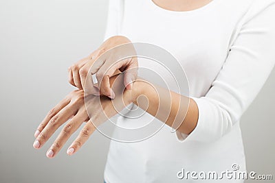 Woman scratching her arm. Stock Photo