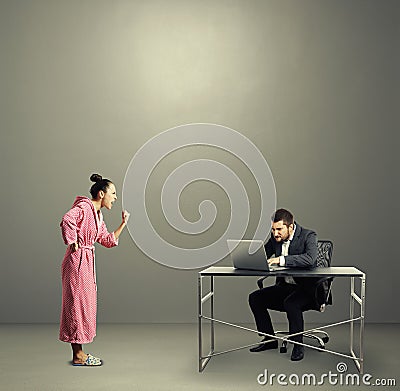 Woman screaming at busy husband Stock Photo