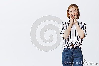 Woman screams from amusement and joy, being amazed. Portrait of attractive active and happy young female employee in Stock Photo