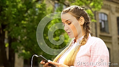 Woman scrolling social networks using phone, new application for music download Stock Photo