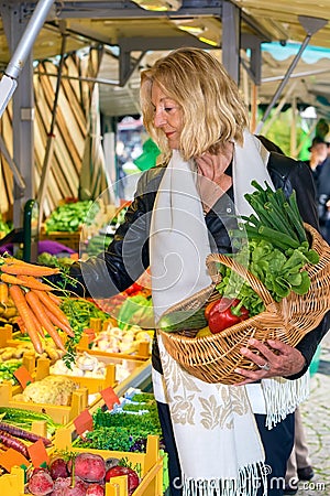 Woman selecting a bunch of fresh carrots Stock Photo