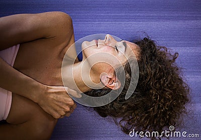 Woman self massage her neck at home improve immune system and reduce pain and tension Stock Photo