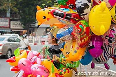 Woman selling colorful balloons Editorial Stock Photo