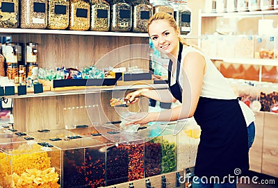 Woman selling dried fruits in store Stock Photo