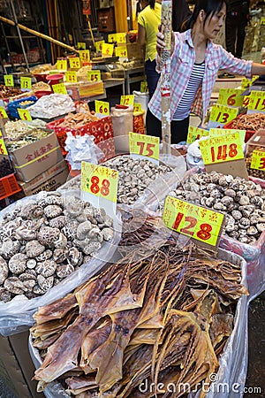 Woman selling dried seafood at a street market in Hong Kong Editorial Stock Photo