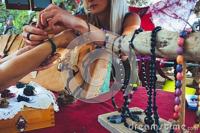 A woman selling homemade craft jewelry from a market stall Editorial Stock Photo