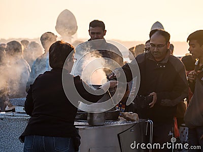 Woman selling roasted chestnuts in Cais das Colunas in Lisbon, P Editorial Stock Photo