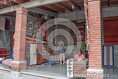 Woman selling traditional handmade rugs. Teotitlan del Valle, Oaxaca, Mexico at a sunny day Editorial Stock Photo