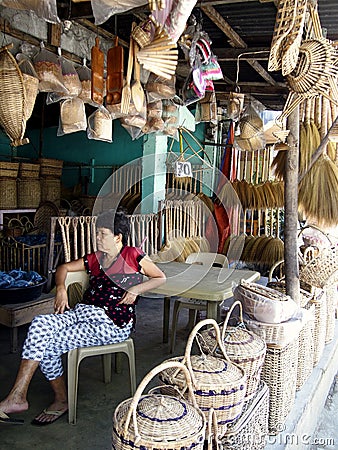 A woman sells different kinds of handicraft and home products Editorial Stock Photo