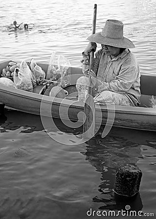 Woman sells fresh fruits from her boat in Thailand Editorial Stock Photo