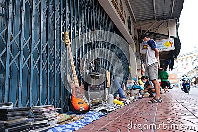 Woman sells miscellaneous items on the sidewalk Editorial Stock Photo