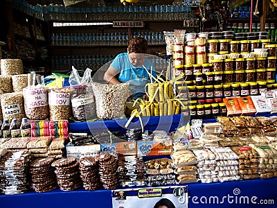 A woman sells a variety of local food Editorial Stock Photo