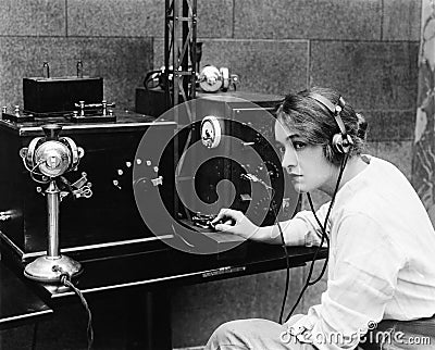Woman sending Morse code using telegraph Stock Photo