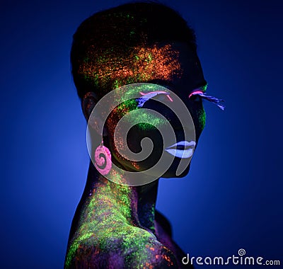 Woman sensual posing in fluorescent paint makeup Stock Photo