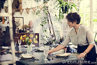 Woman setting a table for the customers Stock Photo