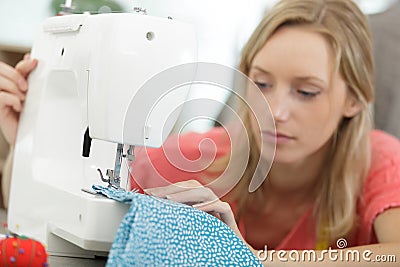 woman sewing fabric with sewing equipments Stock Photo