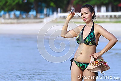 Woman shape symbol show bikini relax on beach Stock Photo