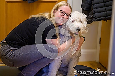 Woman hugs her loyal Old English Sheepdog Stock Photo