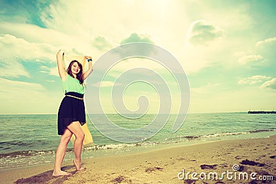Woman with shawl running on beach Stock Photo