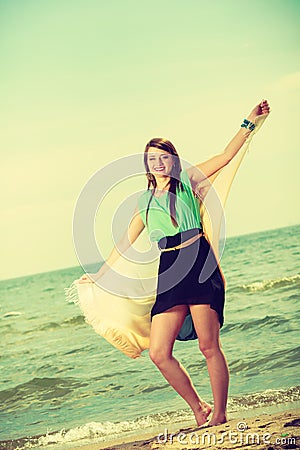 Woman with shawl running on beach Stock Photo