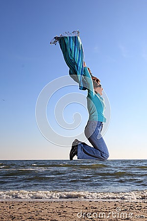 Woman and shawl at sea shore Stock Photo