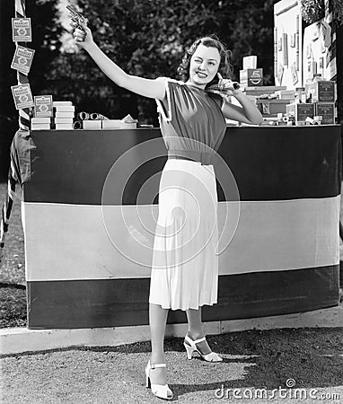 Woman shooting a gun into the air Stock Photo