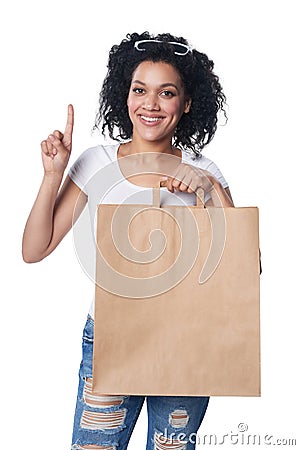 Woman with shopping bag finger up Stock Photo